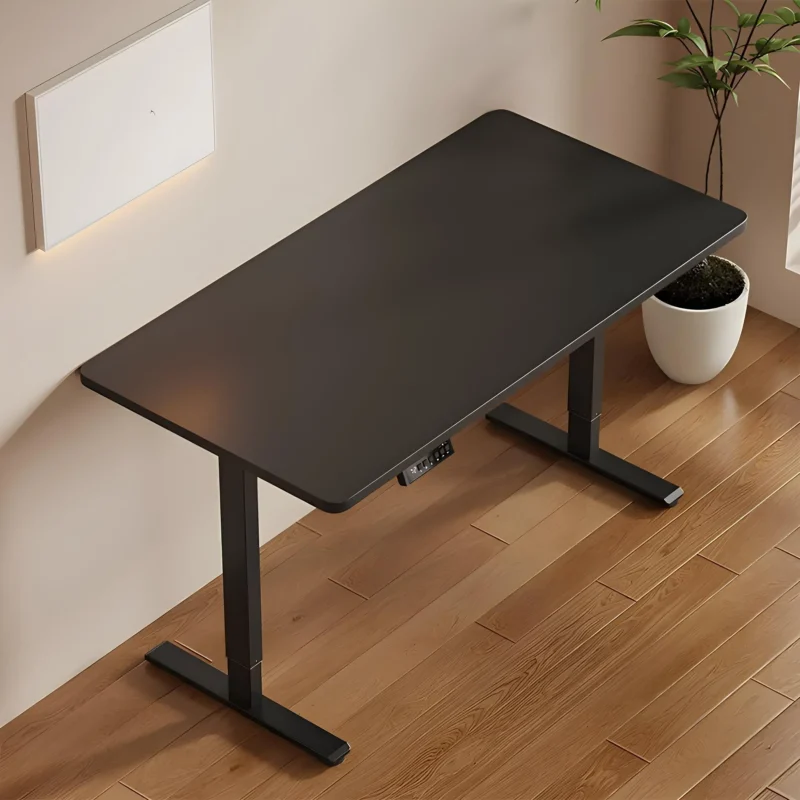 Modern black adjustable office desk with rectangular tabletop and sturdy metal legs on wooden floor.