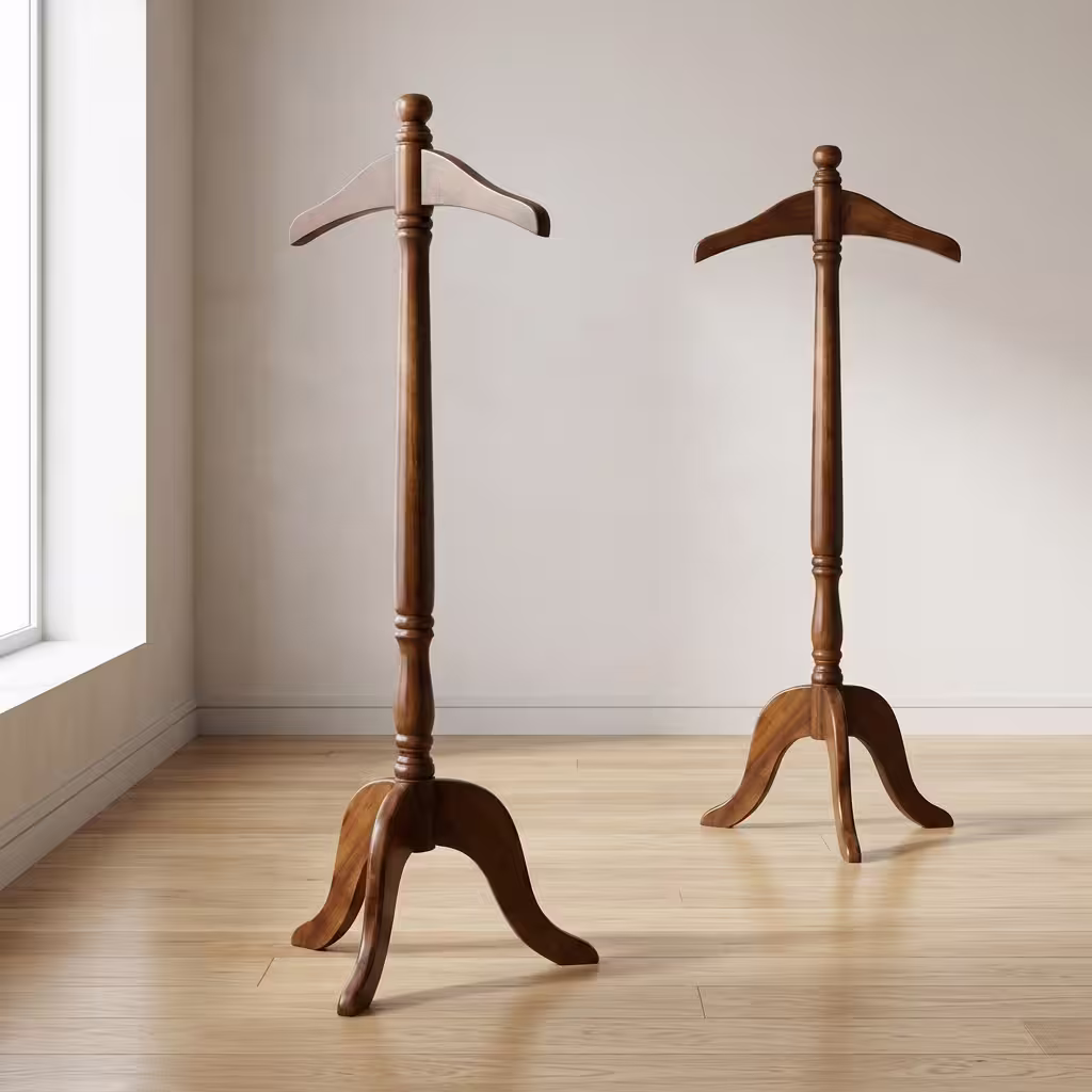 Mahogany Wooden Valet Stand featuring a contoured solid wood suit hanger, an elegant turned pillar neck, a rich mahogany finish, and an arched three-legged pedestal base.
