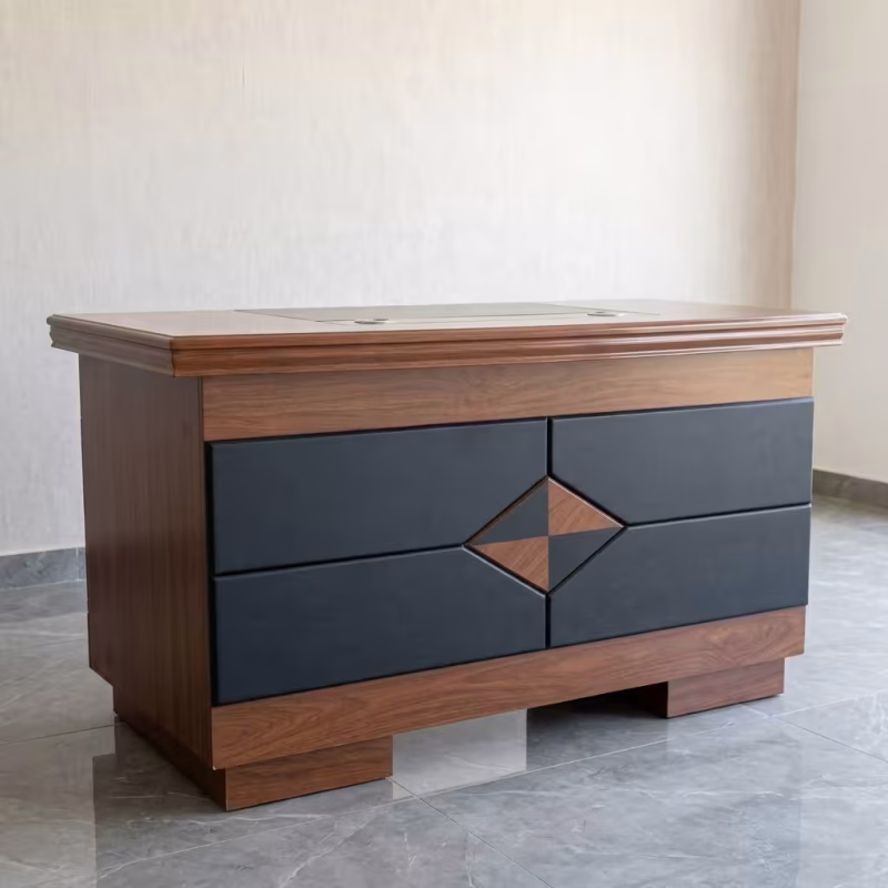 1.2M Mahogany Executive Desk featuring a thick mahogany wood grain floating tabletop, an integrated charcoal grey side storage pedestal, and a grey modesty panel with horizontal gold accent stripes.