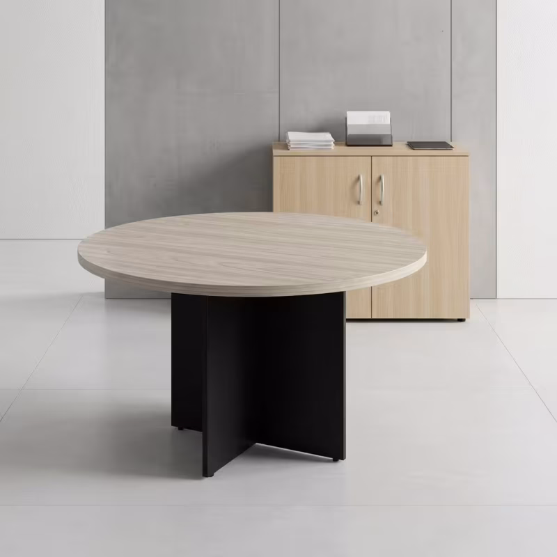 Round Office Meeting Table featuring a natural oak wood-grain circular tabletop with a central silver cable management flip-cover, supported by a matte black steel base.