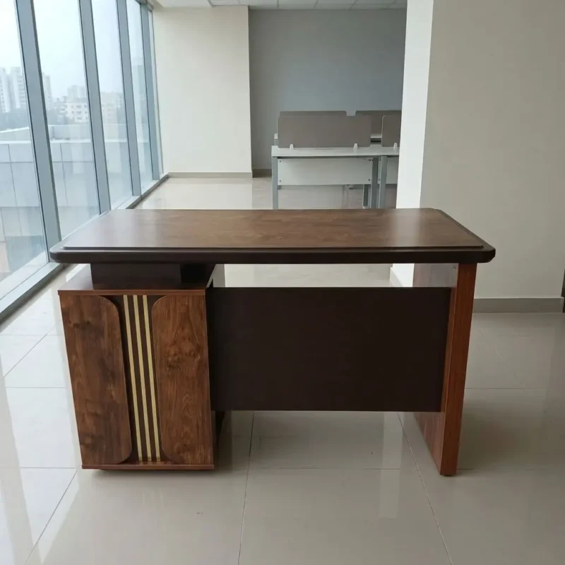 Luxury 1.2m Executive Office Desk in rich walnut wood finish featuring vertical gold accent trim and integrated pedestal in a modern glass-window office.