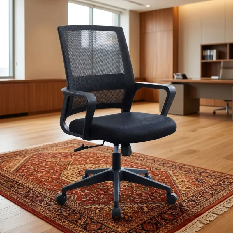 Mid-Back Ergonomic Black Mesh Office Task Chair with fixed loop armrests and black swivel base on an patterned rug in a modern office.
