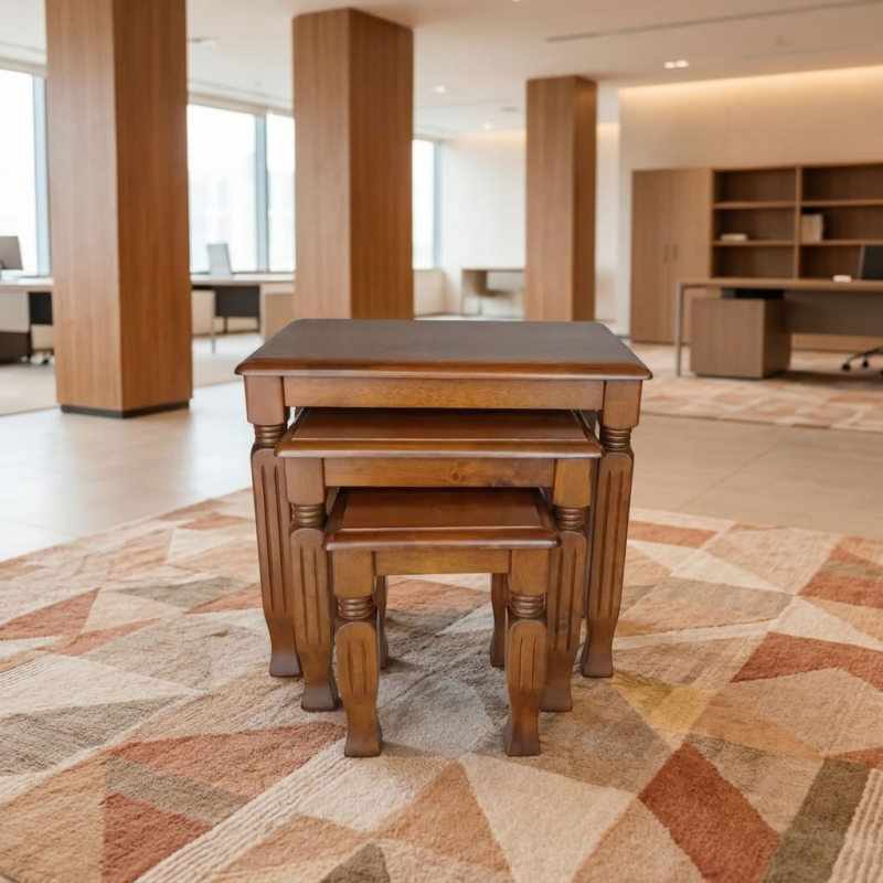 Classic Wooden Nesting Tables Set of 3 in a rich walnut finish with turned legs on a patterned carpet inside a bright corporate office lounge